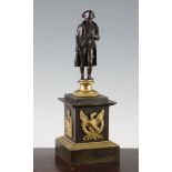 A late 19th / early 20th century French bronze and ormolu figure of Napoleon, on a circular socle