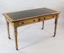 A Victorian birds eye maple and walnut two drawer writing table, with gilt tooled green leather