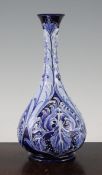 A Macintyre Moorcroft Florian Ware Iris pattern bottle vase, c.1900, decorated with stylised white
