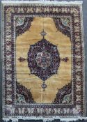 A Central Persian style carpet, with central geometric medallion, on a gold ground, with