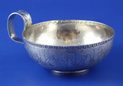 A George V antique Greek style silver shallow drinking cup, with loop handle and engraved