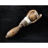 A 19th century carved treen nutcracker, modelled as a hand with unmarked silver ferrule, 6.25in.