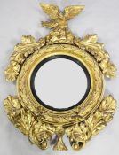 A Regency gilt wood and gesso girandole, with circular convex mirror, within a stiff leaf frame