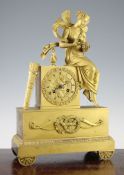 An early 19th century French ormolu mantel timepiece, of architectural form surmounted with a figure