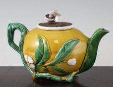 A Minton majolica teapot in the form of a lemon, with moulded leaves and 'mushroom' cover, date mark