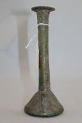 A Roman green glass unguentarium, c.2nd century AD, with a long cylindrical neck and short conical