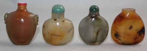 Four Chinese chalcedony snuff bottles, 1800-1900, the first with panelled sides and lion mask ring