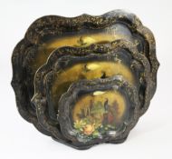 A graduated set of three Victorian papier mache trays, with serpentine borders and painted with