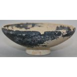 A Greek blackware pottery bowl, Apulia c.4th / 3rd century BC, of shallow curved and a circular