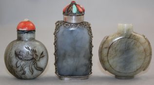 Three Chinese pale grey jade snuff bottles, 1850-1940, the first of watch form with an oval foot,