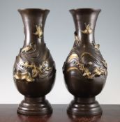 A pair of Japanese parcel gilt bronze baluster vases, 19th century, each cast in relief with