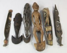 A Papua New Guinea Sepik River wooden tribal food hook, carved as a woman giving birth; two other