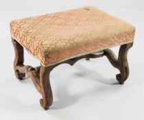 A 19th century Continental walnut stool, with rectangular over-stuffed seat, on scrolling legs