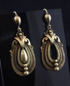 A pair of Victorian gold drop earrings, of pierced graduated loop form, with scroll shoulders and