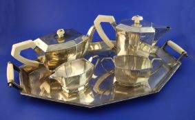 A 1930's Art Deco silver and ivory mounted five piece tea service, comprising teapot, hot water jug,