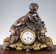 A 19th century French bronze and ormolu mantel clock, surmounted with a figure of a putto and a