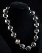 A white metal mounted rock crystal 'pools of light' choker necklace, set with seventeen spherical
