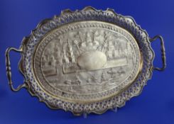 An early 20th century Indian silver oval two-handled tray, embossed with landscape scene with