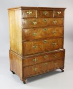 An 18th century walnut chest on stand, fitted three short and three graduated drawers with feather