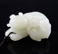 A Chinese pale celadon jade group of two cats, each recumbent and biting a sprig of flowers, the