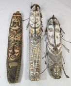 A Papua New Guinea Sepik River wooden ancestor spirit board, of elongated form, carved and painted