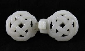 A Chinese pale celadon jade two piece belt buckle, 19th century, each piece carved as interlaced