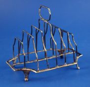 A George III silver seven bar toast rack, of shaped rectangular form, with canted corners, John