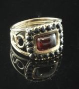 A William IV gold, foil backed garnet? and jet mourning ring, with ring pierced shoulders and