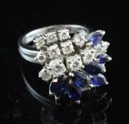 An 18ct white gold sapphire and diamond cluster dress ring, set with graduated round brilliant cut
