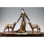 A French Art Deco patinated metal and ivorine figure group of a standing female and two attendant