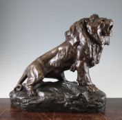 A French Art Deco patinated metal model of a lion, on a rocky base, signed T. Cartier, 16in.