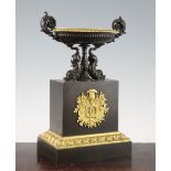 A French bronze and ormolu oval two handled urn, with gadrooned body and dolphin supports, on