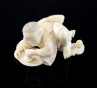A Japanese carved ivory okimono of a child with a spinning top, 19th century, 17.6cm