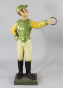 A 20th century polychrome painted cast iron lawn jockey, of two piece construction, possibly