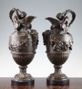 A pair of 20th century bronze urns, each modelled as a 'Sacred to Bacchus' ewer after John