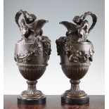 A pair of 20th century bronze urns, each modelled as a 'Sacred to Bacchus' ewer after John