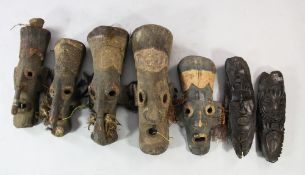 Papua New Guinea Sepik River, a collection of five similar carved wood masks, of elongated form,