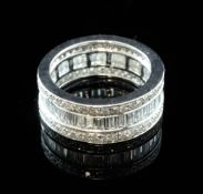 An 18ct white gold triple band diamond full eternity ring, set with round cut and channel set
