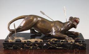 Louis Caruin. A French Art Deco patinated bronze model of a wounded tiger, with three darts, on