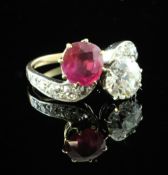 A gold, ruby and diamond crossover ring, with diamond set shoulders, the round cut ruby and