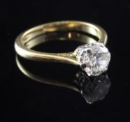 An 18ct gold and claw set solitaire diamond ring, the round cut stone weighing approximately 0.55ct,