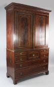 An early 19th century Scottish mahogany satinwood banded linen press, with two doors above central