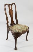 An early 18th century walnut side chair, with drop in tapestry seat, on cabriole legs and pad feet