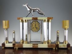 Attributed to Michel Decoux. A French Art Deco marble, onyx and chrome clock garniture, the clock