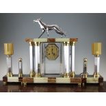 Attributed to Michel Decoux. A French Art Deco marble, onyx and chrome clock garniture, the clock