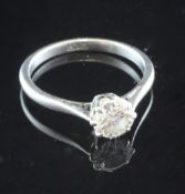 A platinum and solitaire diamond ring, the round cut stone weighing approximately in excess of 0.