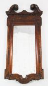 A mid 18th century style walnut wall mirror, with broken swan neck pediment, with rectangular shaped