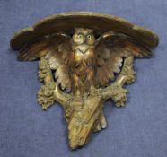 A late 19th / early 20th century Black Forest carved wall bracket, modelled as an owl, with glass