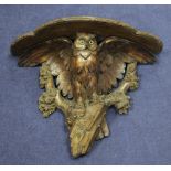 A late 19th / early 20th century Black Forest carved wall bracket, modelled as an owl, with glass