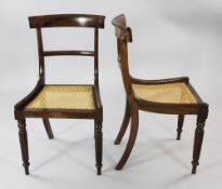 A set of six early 19th century rosewood dining chairs, with shaped crest rails and caned seats,